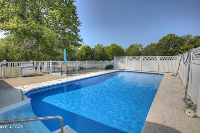 9825 County Rd 215, Webb City, MO 64870 - view of swimming pool featuring a patio area, a fenced backyard, and view of scattered trees