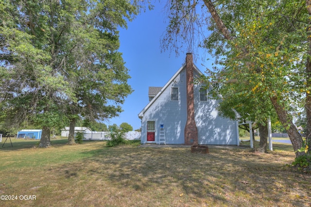 9825 County Rd 215, Webb City, MO 64870 - view of side of property with a chimney and a fire pit