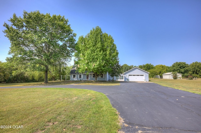 9825 County Rd 215, Webb City, MO 64870 - view of front of house with a front yard, driveway, and view of wooded area