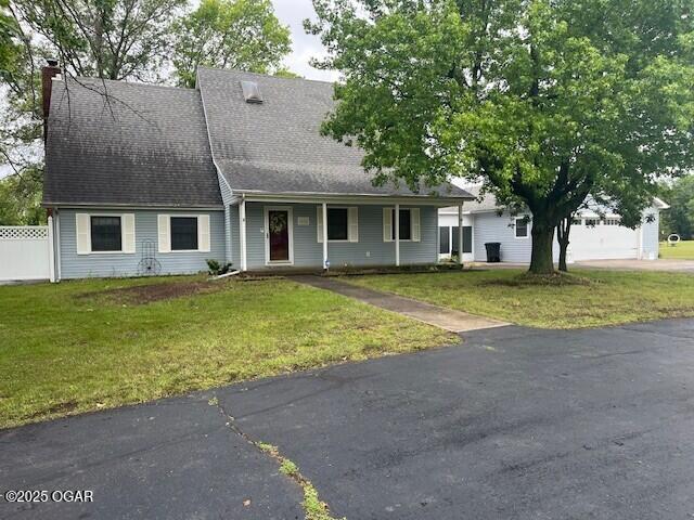 9825 County Rd 215, Webb City, MO 64870 - view of front of property featuring a chimney, a shingled roof, a porch, driveway, and a garage