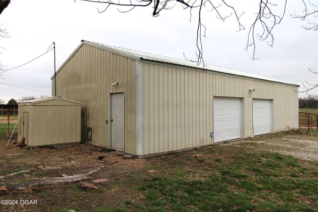 garage featuring wooden walls