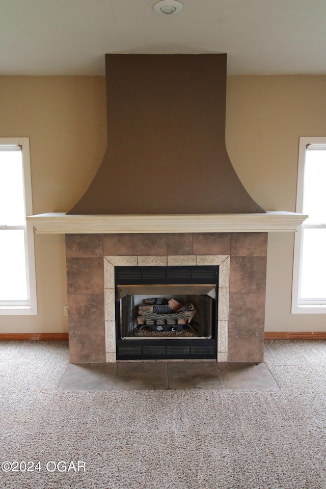 interior details with a fireplace and carpet