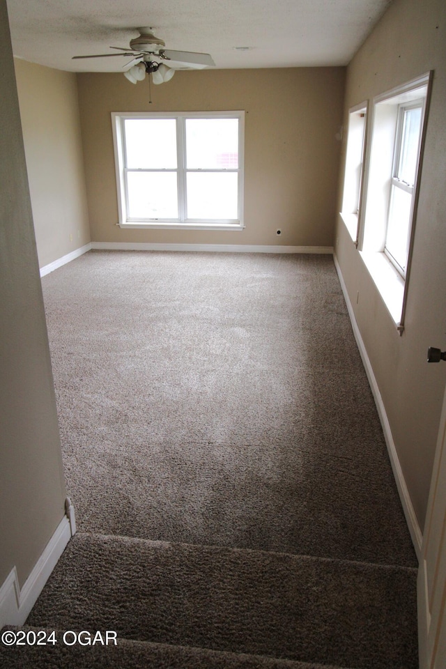 carpeted empty room with ceiling fan