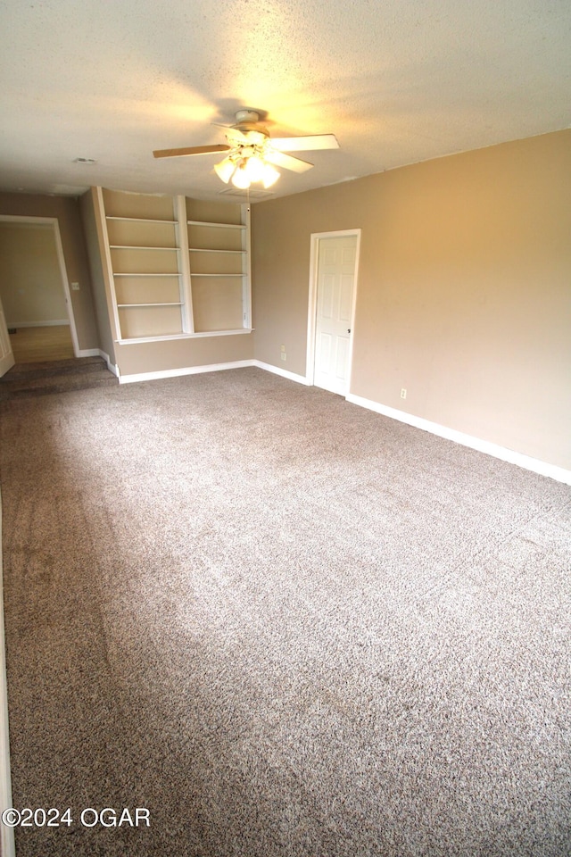 interior space featuring a textured ceiling, carpet, ceiling fan, and a closet