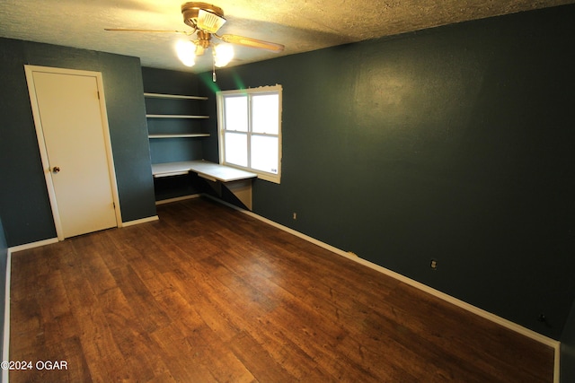 unfurnished bedroom with a closet, ceiling fan, dark wood-type flooring, and a textured ceiling