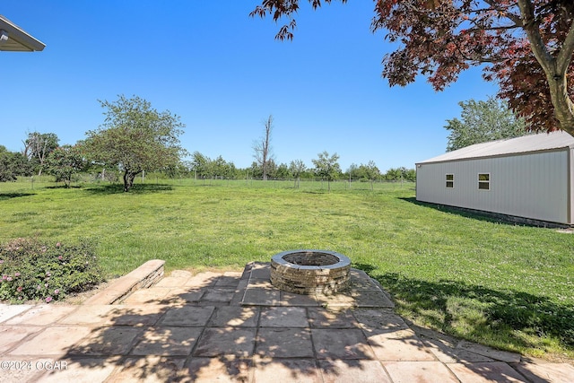 view of yard with a patio area and an outdoor fire pit