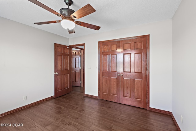 interior space with a textured ceiling, dark wood-type flooring, and ceiling fan