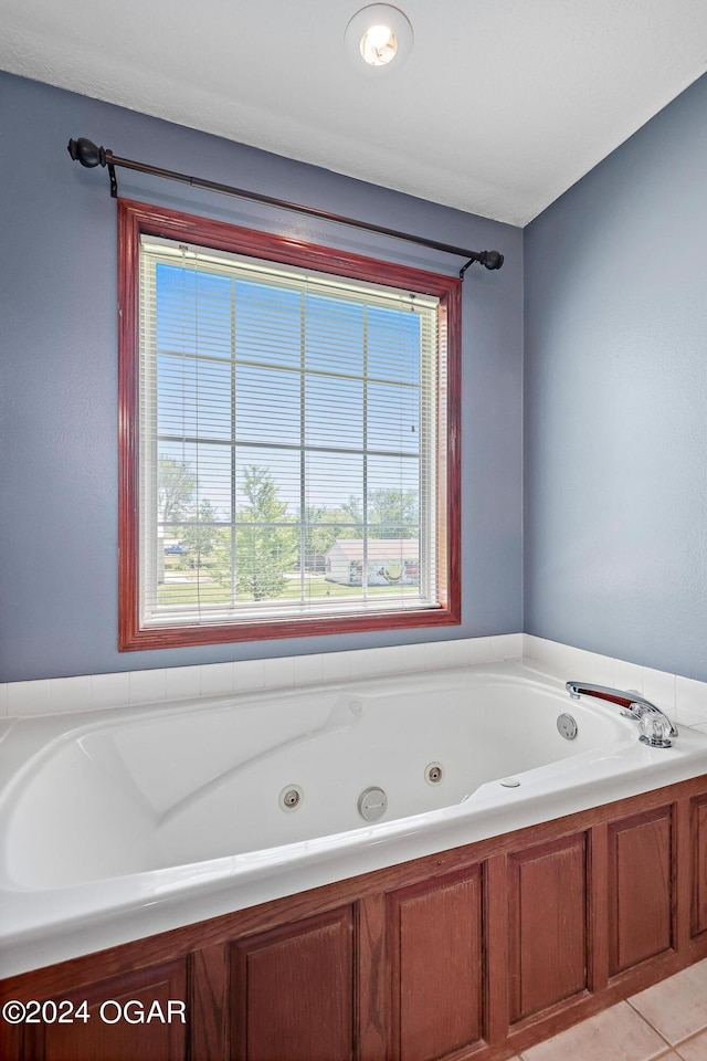 bathroom featuring tile patterned flooring and a tub to relax in