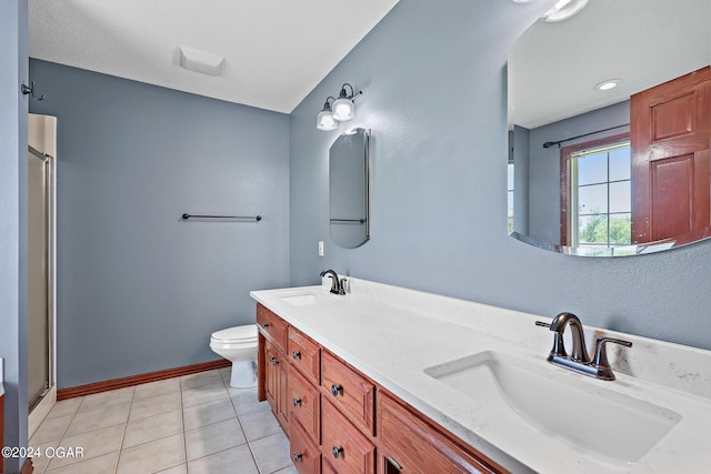 bathroom featuring tile patterned flooring, a shower with door, vanity, and toilet