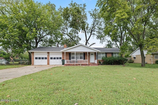 ranch-style home featuring a front yard, a garage, and covered porch