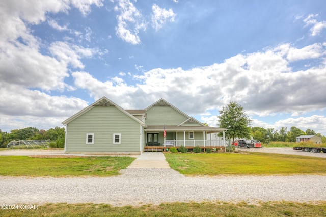 view of front of home with a front yard and covered porch