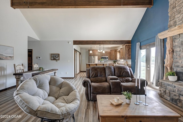 living room with light hardwood / wood-style floors, beamed ceiling, and high vaulted ceiling