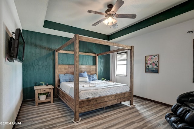 bedroom with hardwood / wood-style floors and ceiling fan