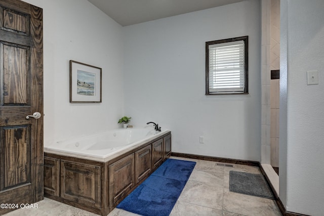 bathroom featuring independent shower and bath and tile patterned floors