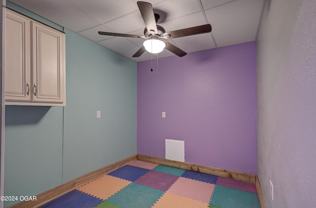 spare room featuring a paneled ceiling and ceiling fan