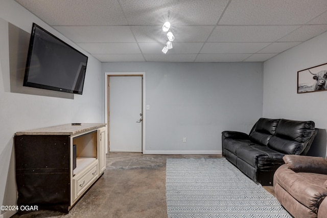 living room featuring carpet and a paneled ceiling