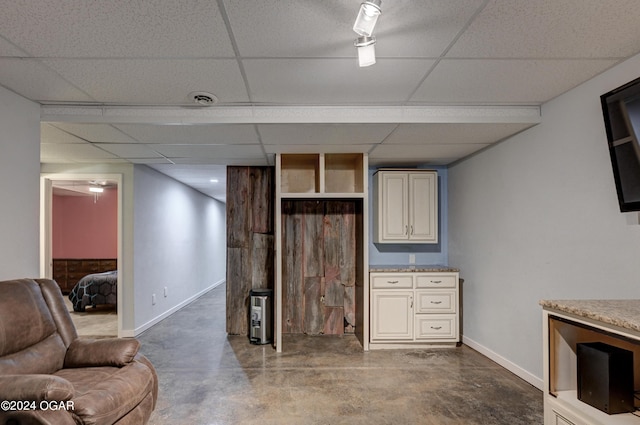 basement featuring a drop ceiling