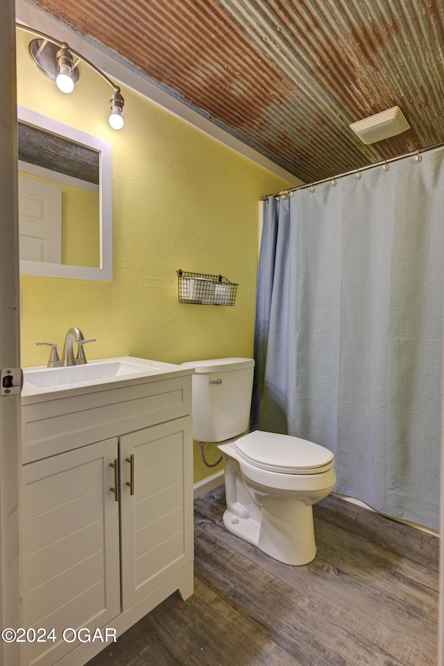 bathroom with a shower with shower curtain, vanity, toilet, and hardwood / wood-style flooring