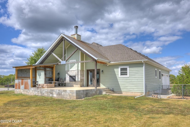 rear view of house featuring a lawn