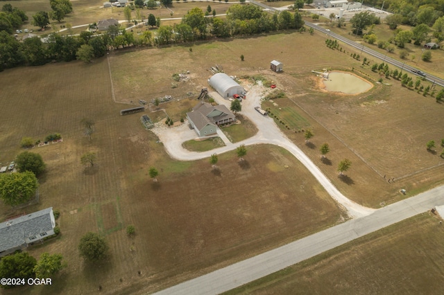 birds eye view of property with a rural view