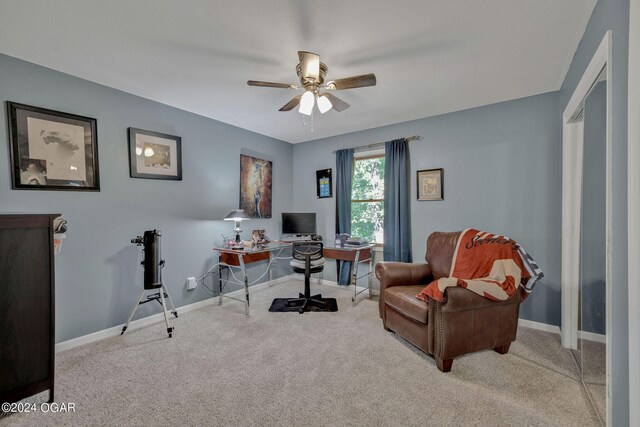 carpeted office featuring ceiling fan