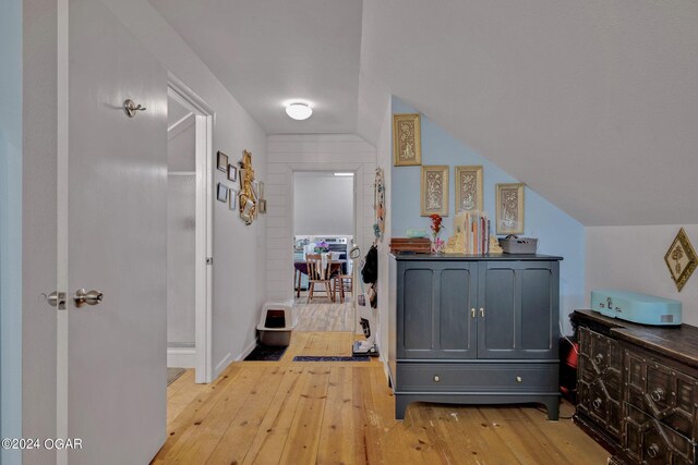 interior space featuring light wood-type flooring and lofted ceiling