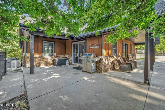 view of patio / terrace featuring area for grilling and a grill