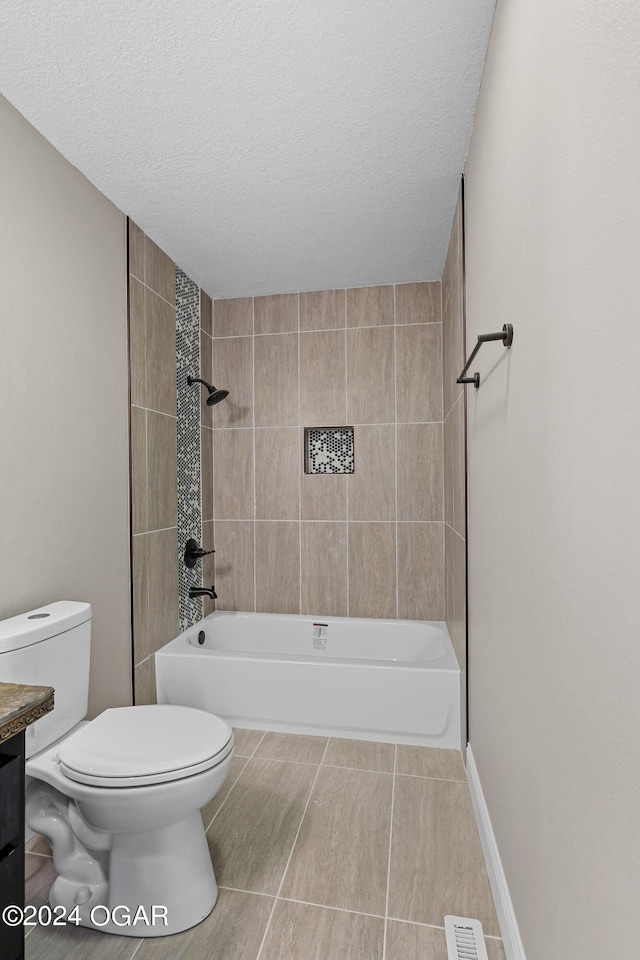 full bathroom with a textured ceiling, tiled shower / bath combo, vanity, and toilet