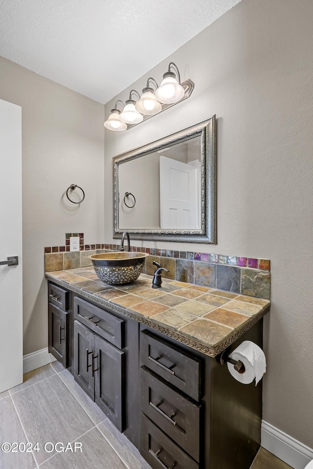 bathroom with decorative backsplash and vanity