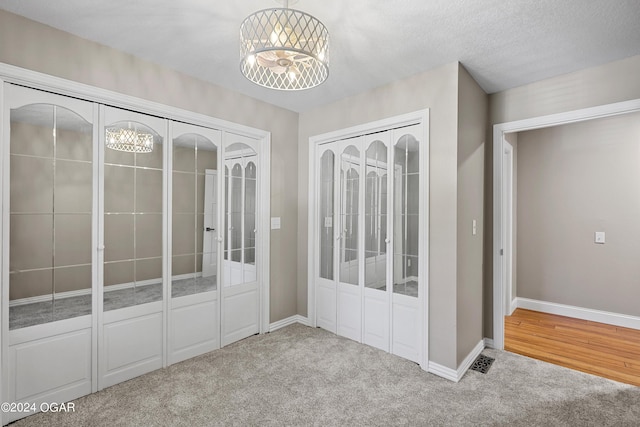 interior space featuring a textured ceiling and a chandelier