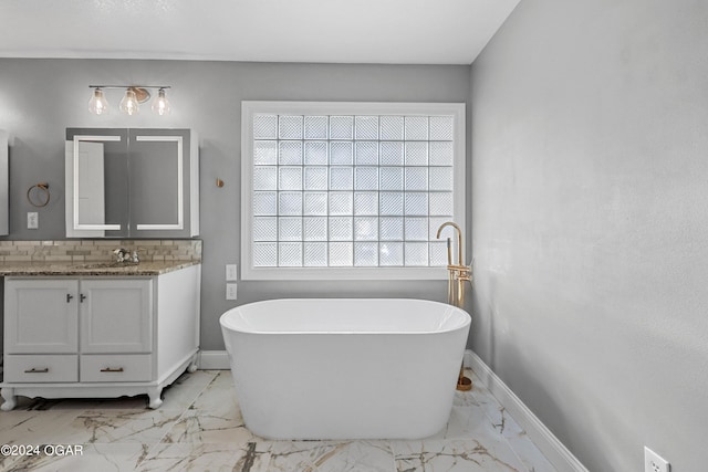 bathroom featuring vanity and a washtub