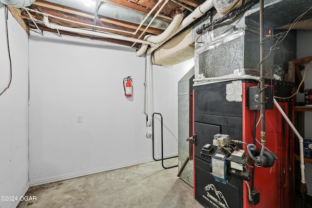 utility room featuring heating unit