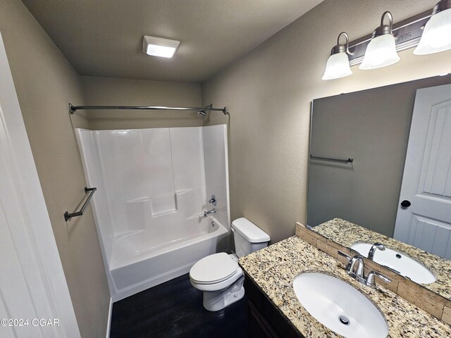 full bathroom with shower / washtub combination, wood-type flooring, vanity, and toilet