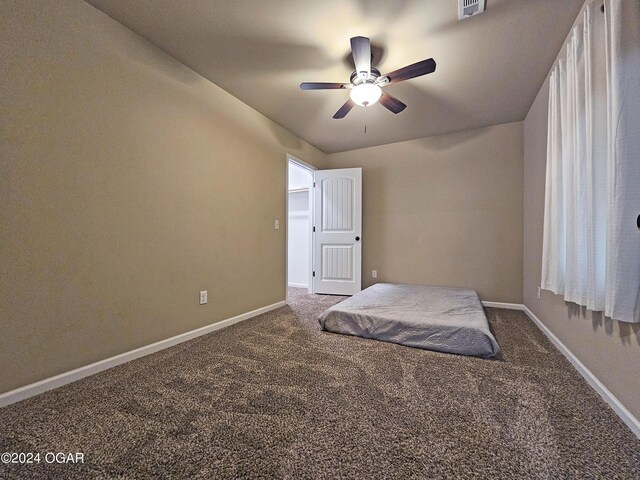 unfurnished bedroom featuring carpet floors and ceiling fan