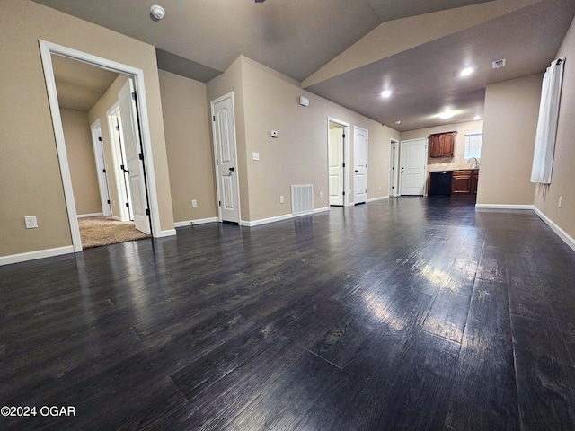 unfurnished living room featuring vaulted ceiling and dark hardwood / wood-style flooring