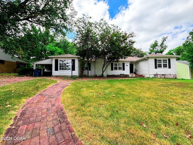 single story home with a carport and a front lawn