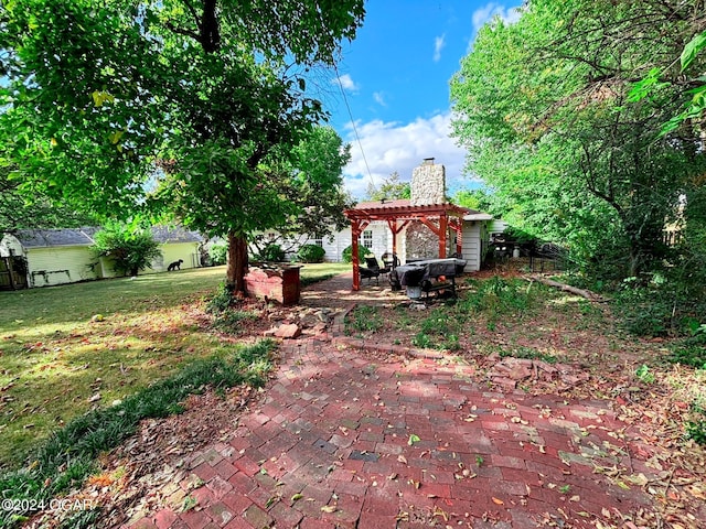 view of yard with a pergola and a patio