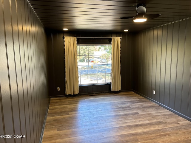 unfurnished room with ceiling fan and hardwood / wood-style flooring