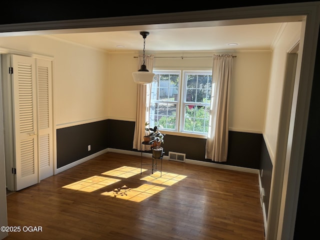 interior space with dark hardwood / wood-style floors and ornamental molding