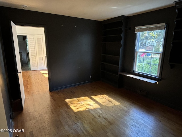 empty room with hardwood / wood-style flooring