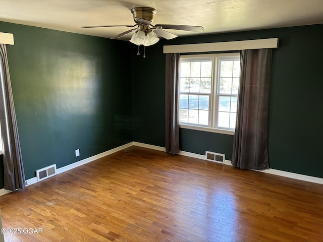 spare room featuring ceiling fan and hardwood / wood-style flooring