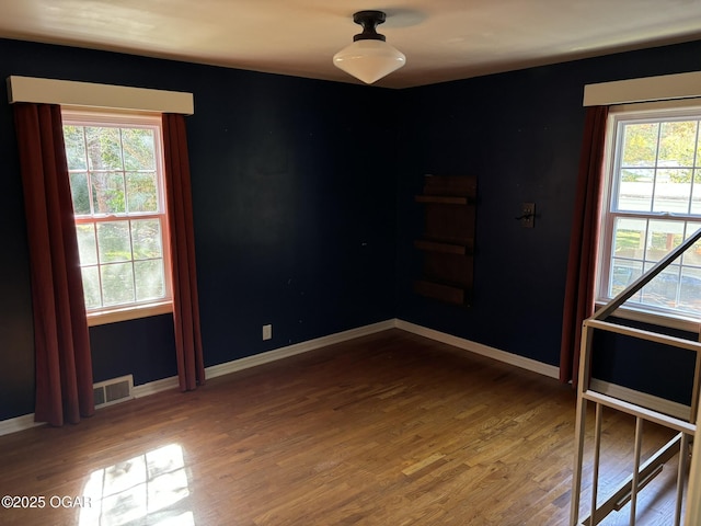 spare room featuring wood-type flooring