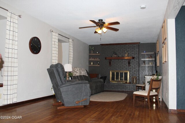 living room with a fireplace, dark hardwood / wood-style floors, and ceiling fan