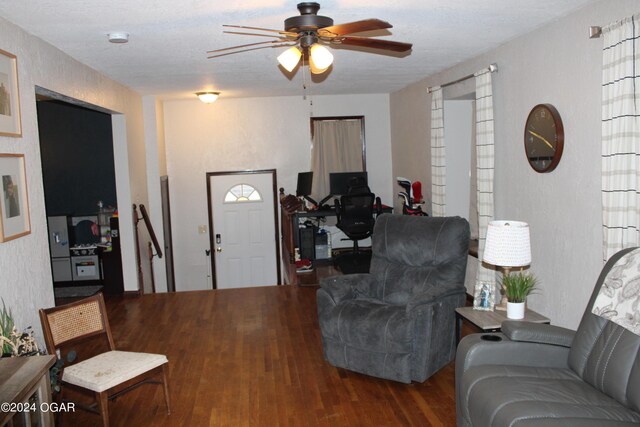 living room with wood-type flooring, a textured ceiling, and ceiling fan