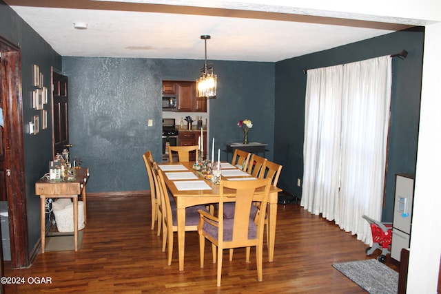 dining space with a chandelier and dark wood-type flooring