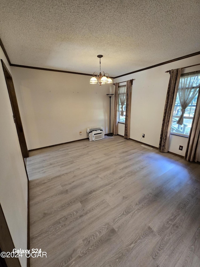 107 Foursome Ln, Carl Junction, MO 64834 - unfurnished dining area with light wood-style floors, crown molding, a textured ceiling, and a chandelier