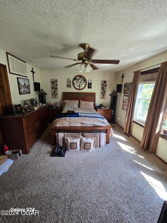 bedroom featuring carpet, ceiling fan, and a textured ceiling