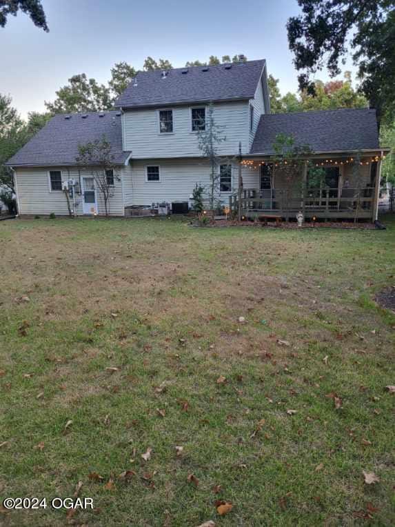 107 Foursome Ln, Carl Junction, MO 64834 - rear view of property featuring a lawn