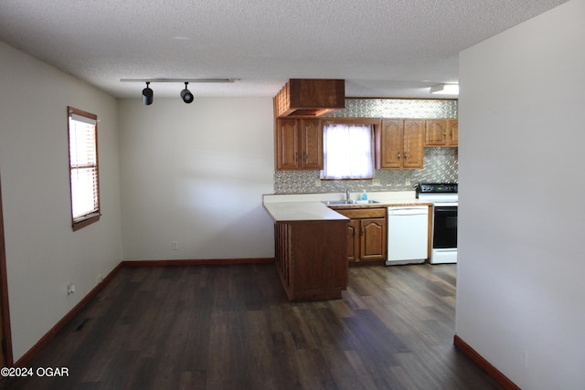 kitchen with dark hardwood / wood-style floors, white appliances, and a wealth of natural light