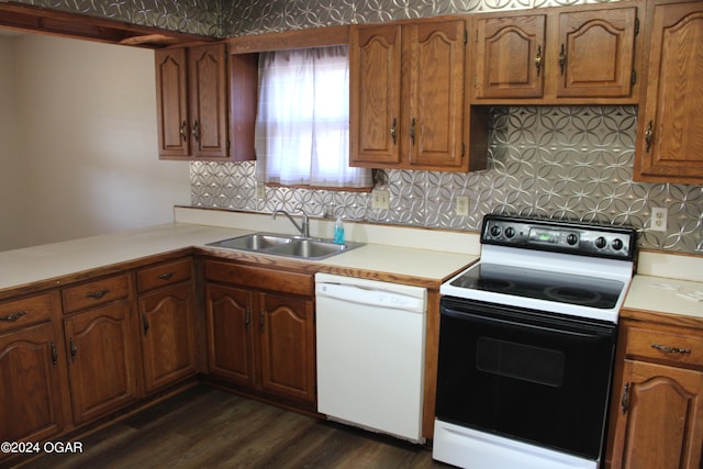 kitchen with dark wood-type flooring, backsplash, sink, and white appliances